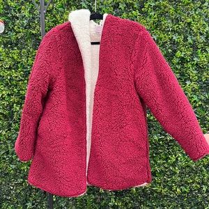 Red/Maroon colored fuzzy jacket.